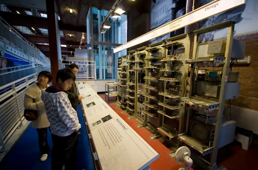 A working replica of the Manchester Baby computer, a tall frame packed with vacuum tubes, dials, and wiring