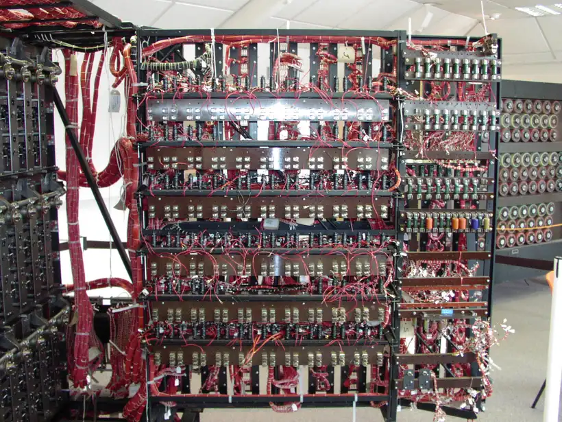 A working rebuild of the Bombe, a large electromechanical codebreaking machine, its face covered in rows of colored rotating drums